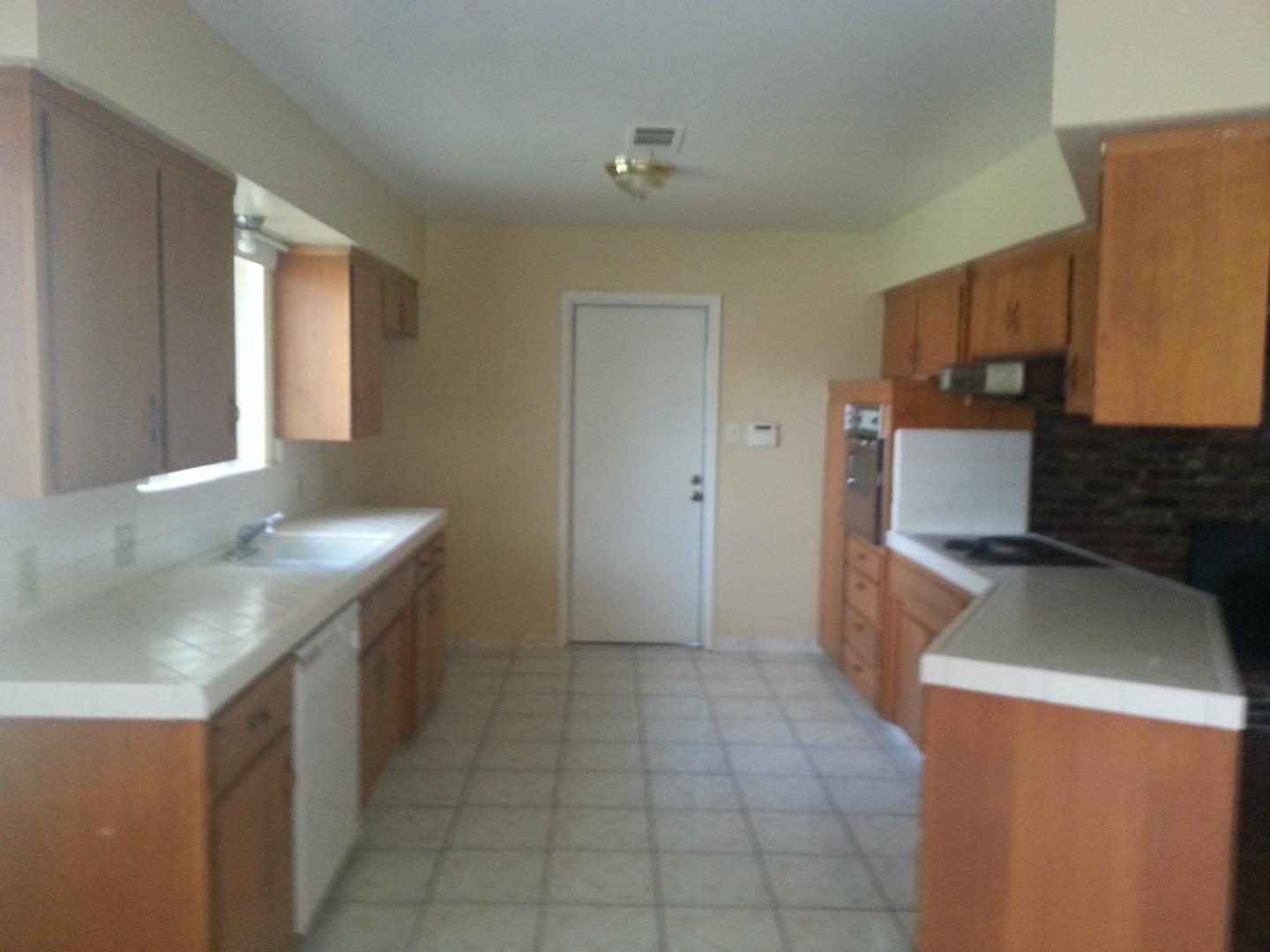856 Modoc Street Merced, CA 95340 - Photo 5 of 16 a kitchen with a sink and a stove top oven