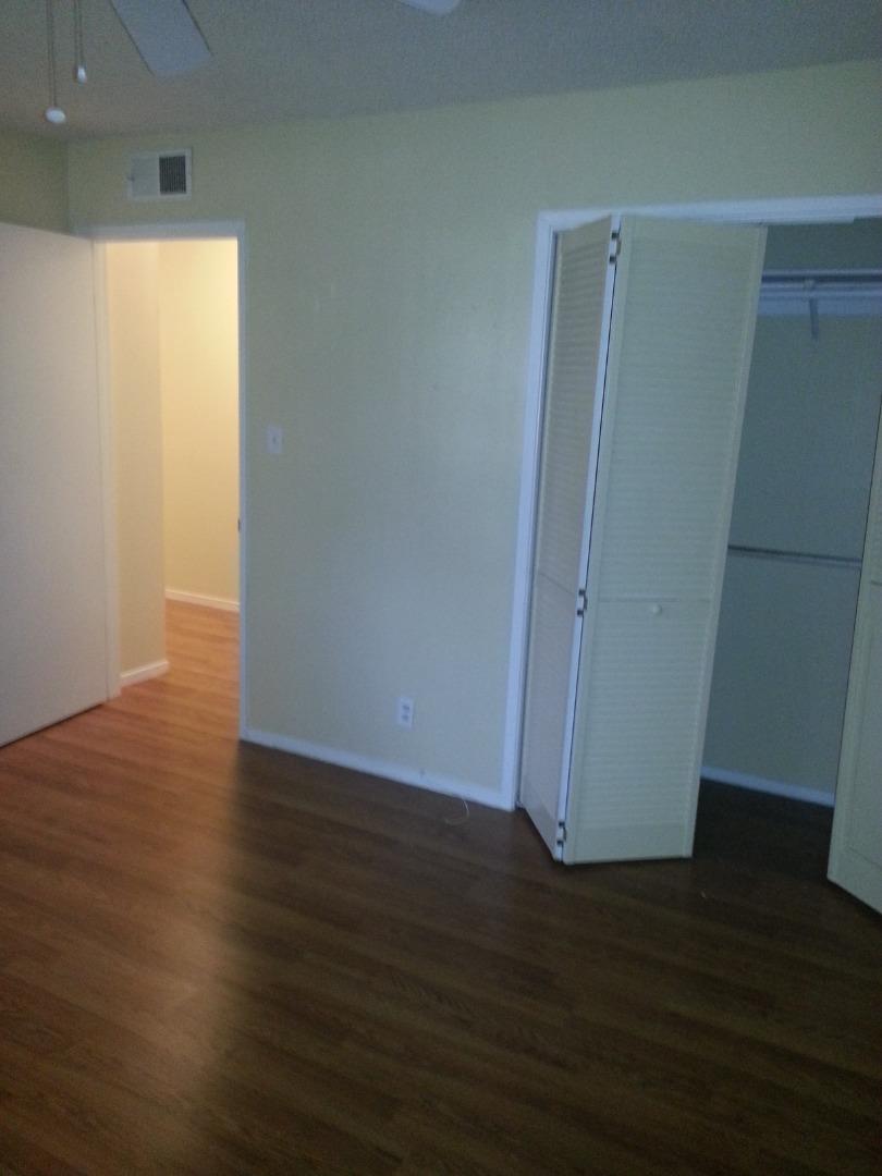 856 Modoc Street Merced, CA 95340 - Photo 10 of 16 an empty room with wooden floor and windows