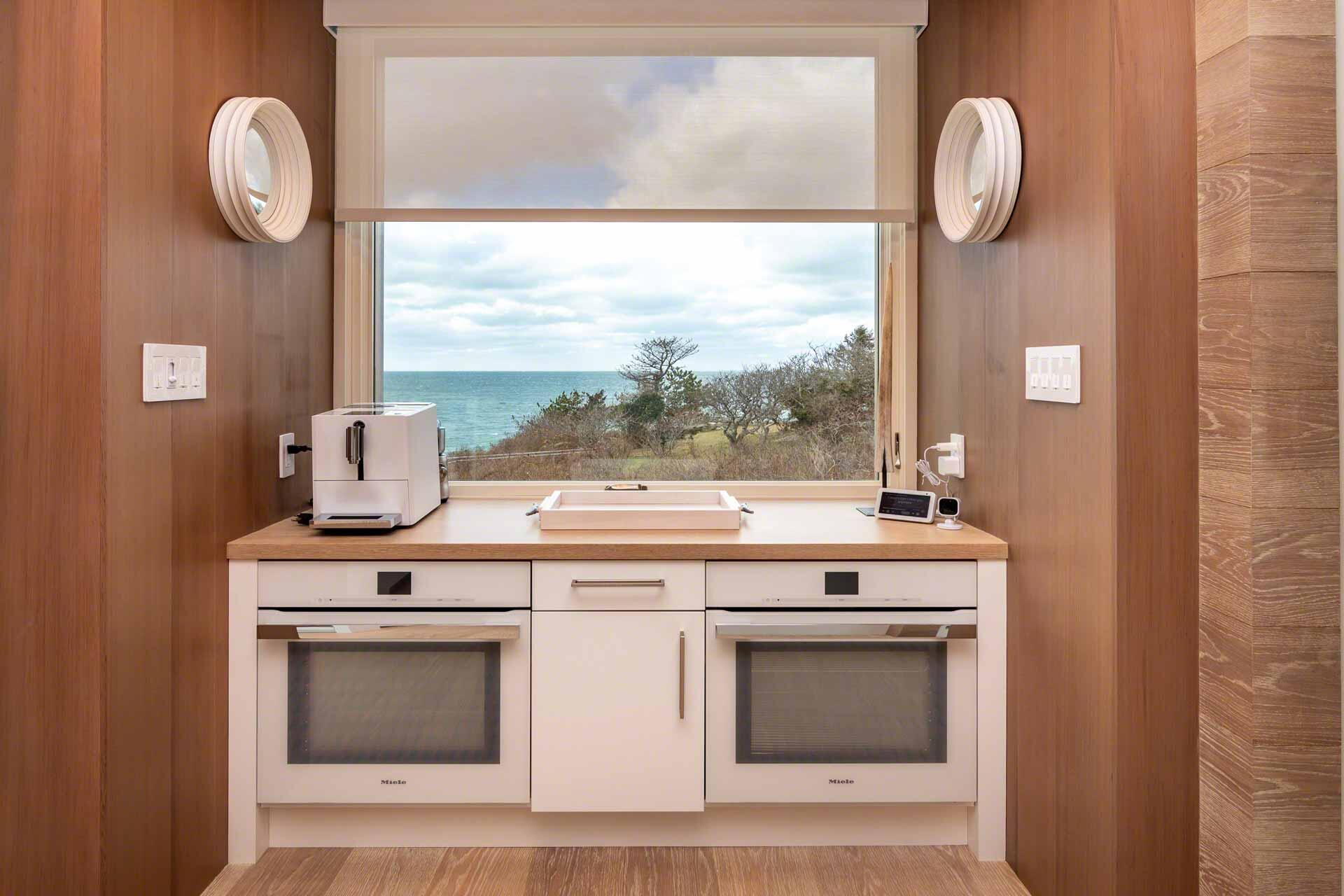 76 Menemsha Inn Road Chilmark, MA 02535 - Photo 15 of 39 a kitchen with a stove and a mirror