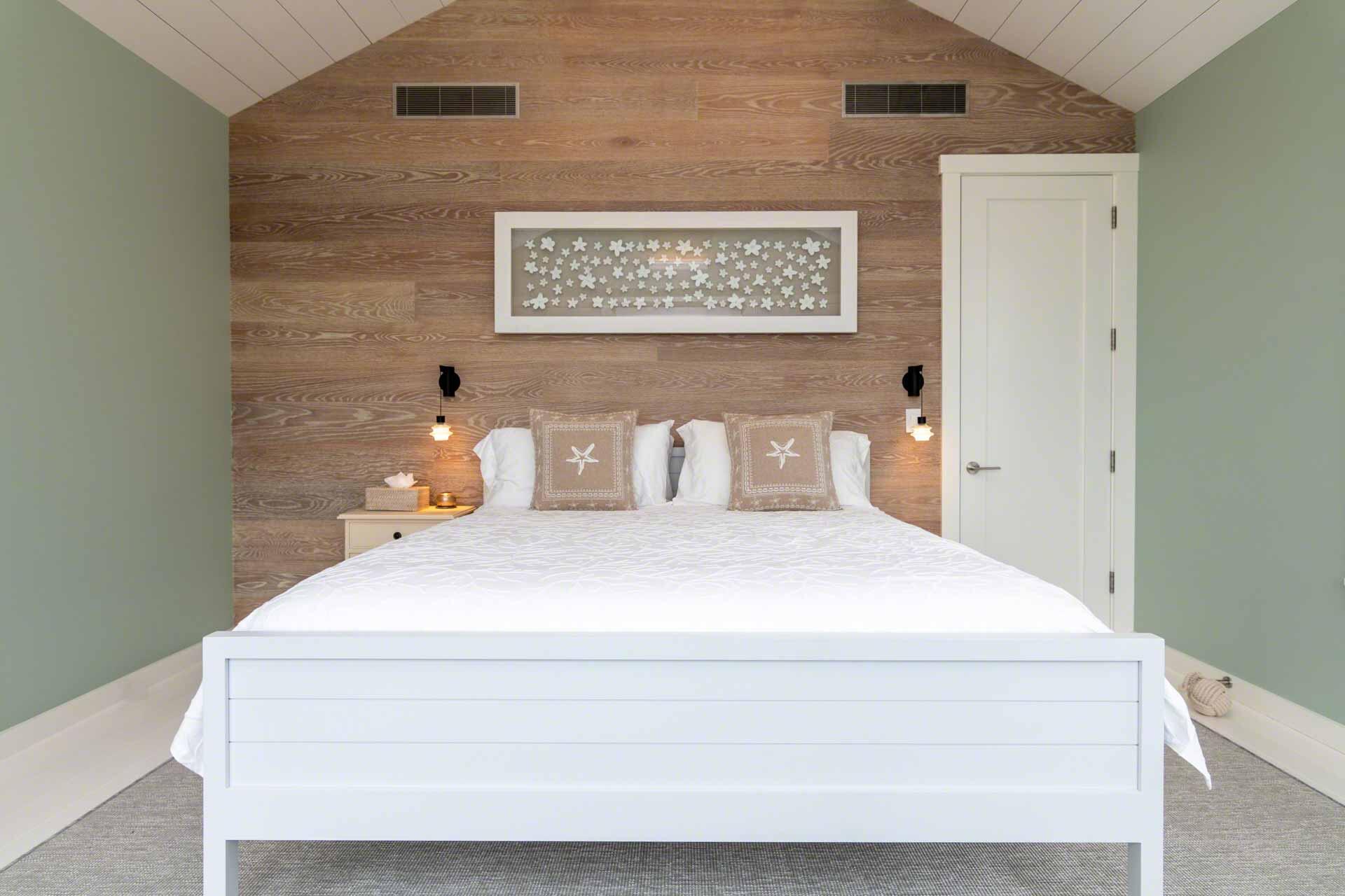 76 Menemsha Inn Road Chilmark, MA 02535 - Photo 21 of 39 a bedroom with a bed and a wall painting