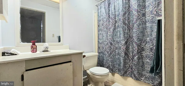 a bathroom with a sink toilet and a mirror