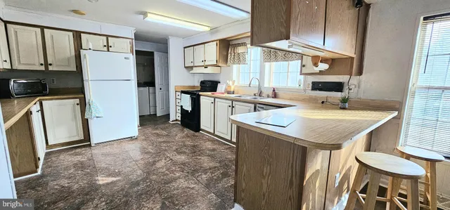 a kitchen with a refrigerator a sink and a stove