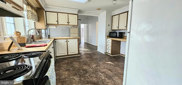 a kitchen with a stove a refrigerator and a sink