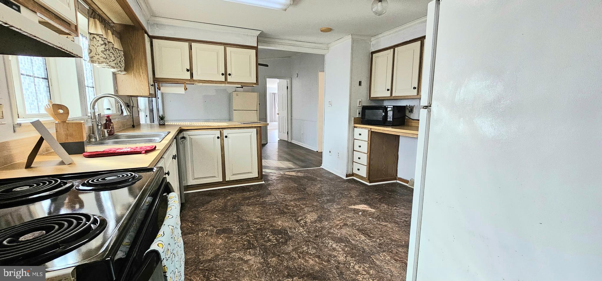 10505 Cedarville Road, Unit 21 Brandywine, MD 20613 - Photo 3 of 16 a kitchen with a stove a refrigerator and a sink