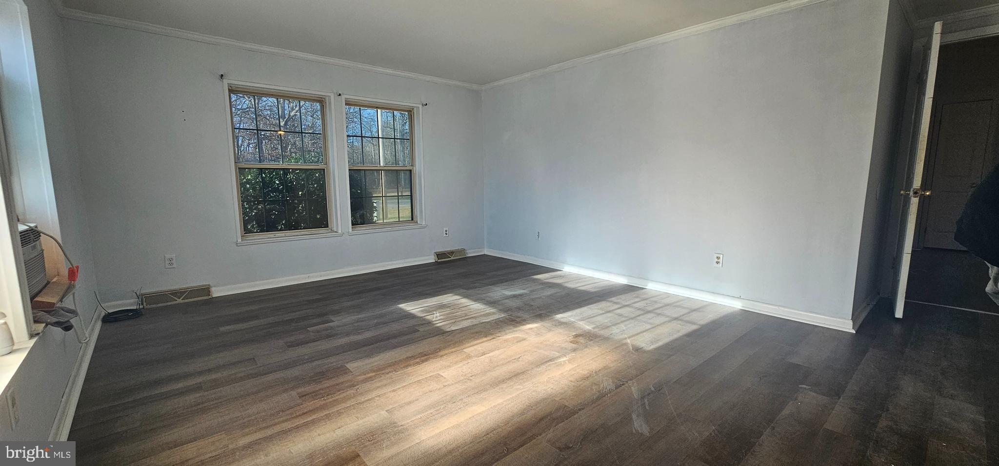 10505 Cedarville Road, Unit 21 Brandywine, MD 20613 - Photo 5 of 16 an empty room with wooden floor and windows