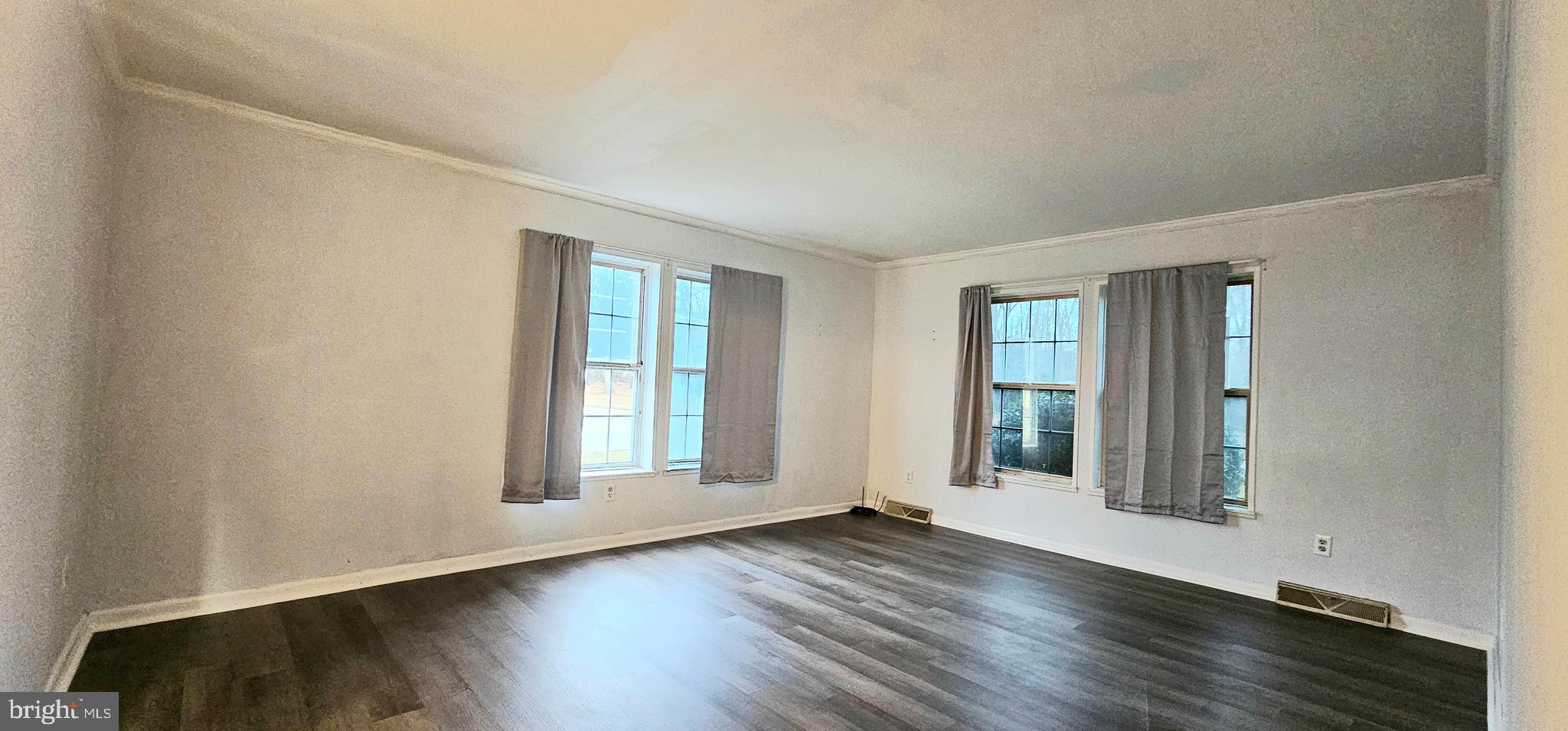 10505 Cedarville Road, Unit 21 Brandywine, MD 20613 - Photo 6 of 16 an empty room with wooden floor and windows