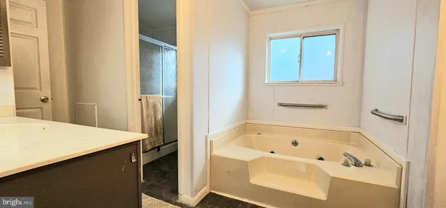 a bathroom with a bathtub and a sink