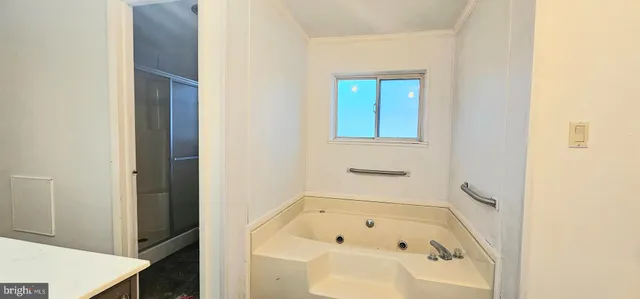 a bathroom with a tub sink and vanity