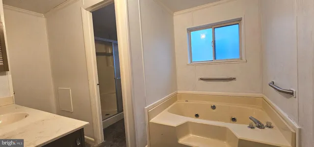 a bathroom with a tub and shower
