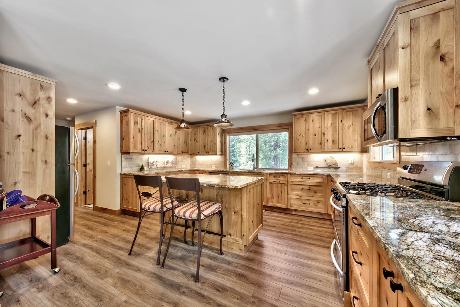 164 Basque Drive Truckee, CA 96161 - Photo 6 of 21 a kitchen with a table chairs stove and cabinets