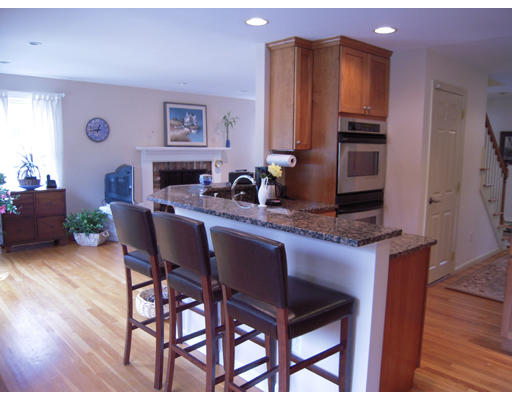 19 Schooner Ridge Marblehead, MA 01945 - Photo 5 of 19 a kitchen with stainless steel appliances a dining table chairs and a refrigerator