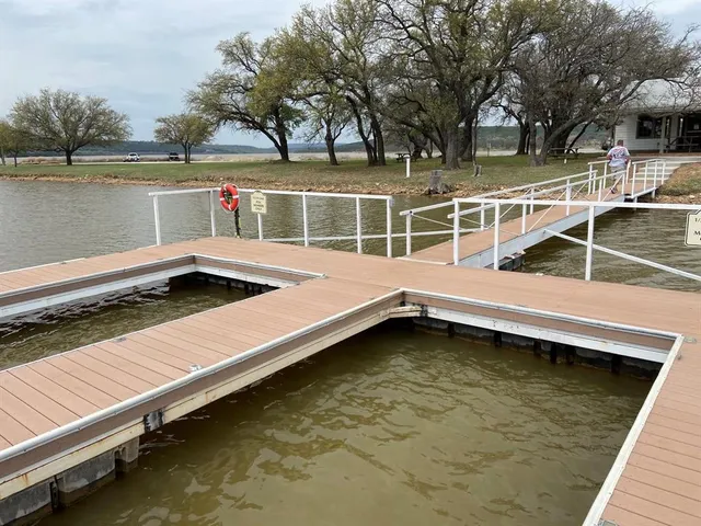 a view of a wooden deck with lake view