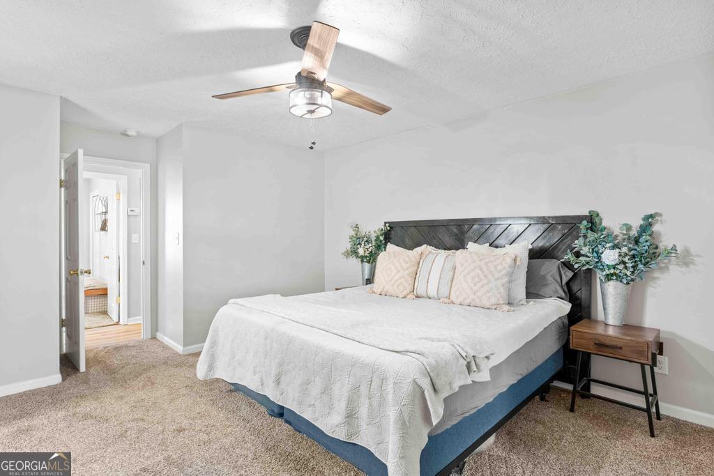 1881 Timberlane Road Milledgeville, GA 31061 - Photo 11 of 28 a bedroom with a bed and a chandelier