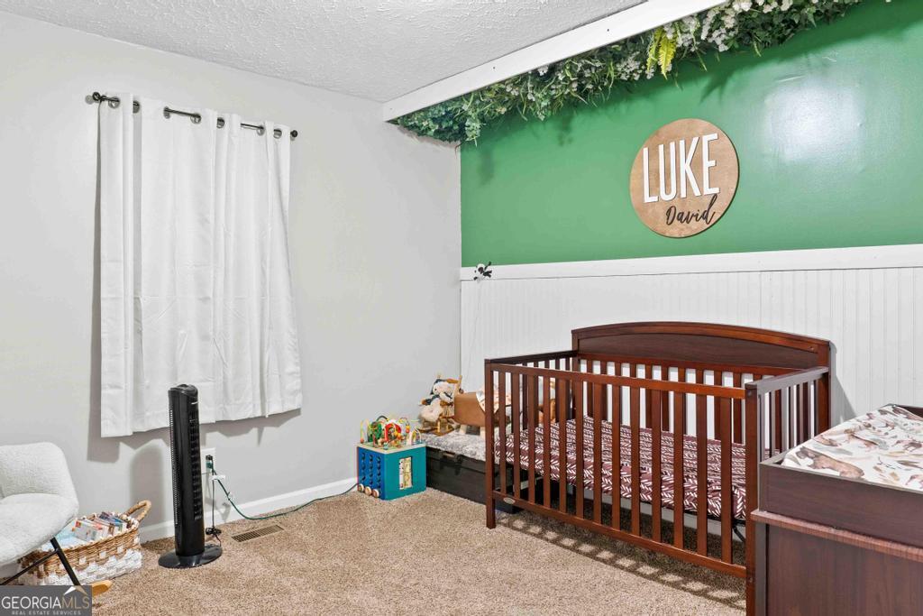 1881 Timberlane Road Milledgeville, GA 31061 - Photo 20 of 28 a bedroom with a bed and a window