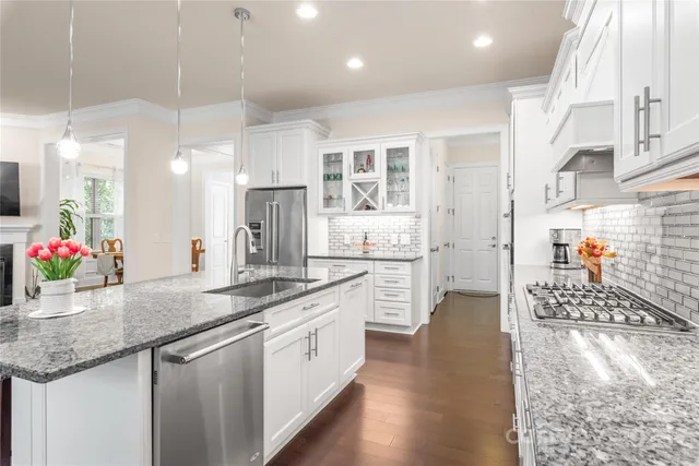 a kitchen with counter top space a sink stove and cabinets