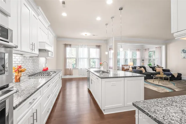 a kitchen with stainless steel appliances a refrigerator and a stove