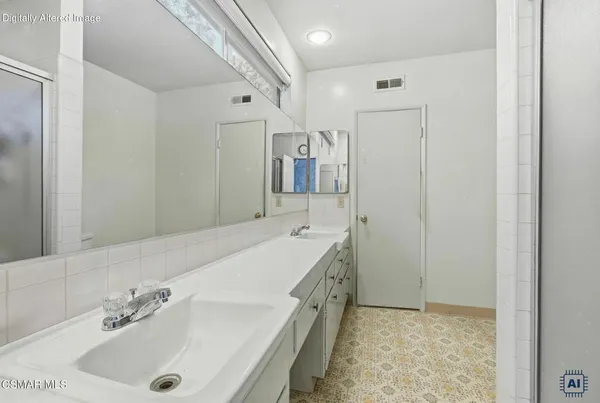 a bathroom with a tub sink and mirror
