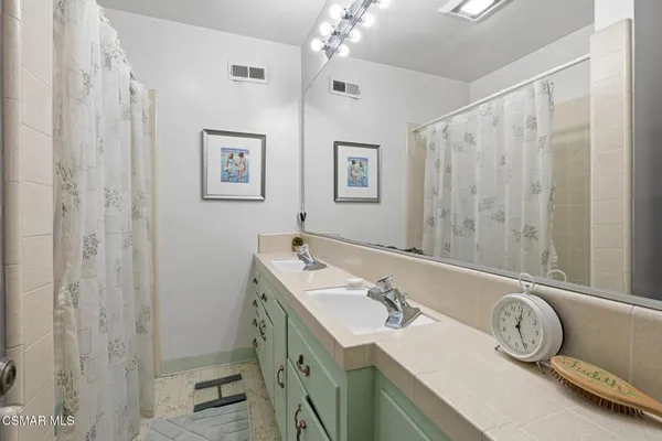 a bathroom with a tub sink and mirror