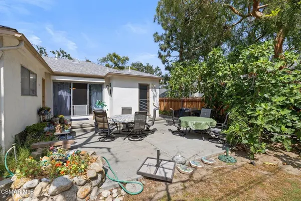 a view of backyard with outdoor seating and plants