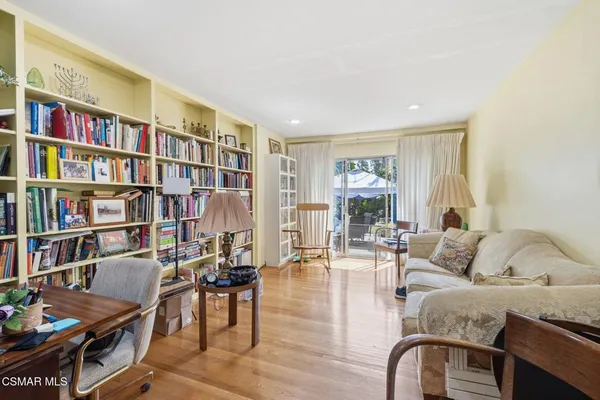 a living room with furniture and a book shelf