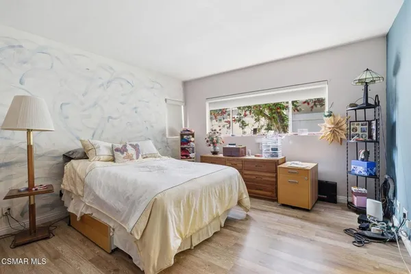 a bedroom with a bed and a large window