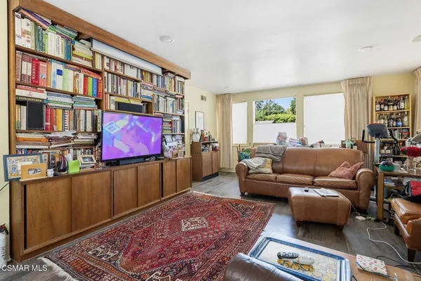a living room with furniture and a book shelf