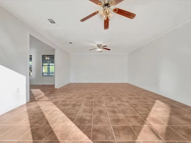 a view of a bedroom with a bed and a chandelier fan
