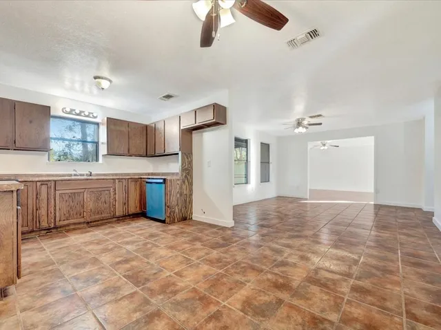 a view of a kitchen with a sink and cabinets