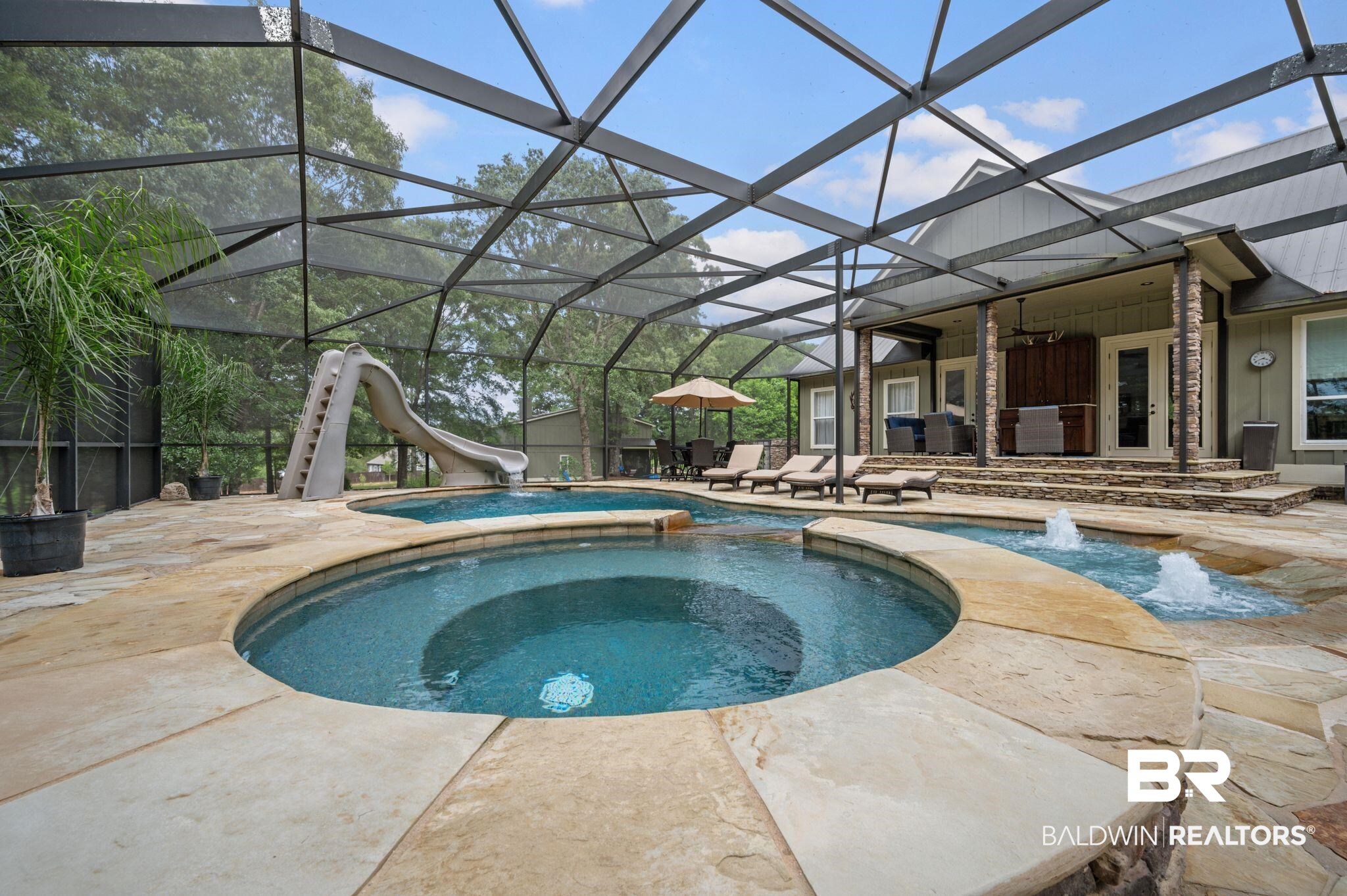 14591 Styx River Road Stapleton, AL 36578 - Photo 34 of 47 View of swimming pool with a water slide, a patio, a ceiling fan, a pool with connected hot tub, and glass enclosure