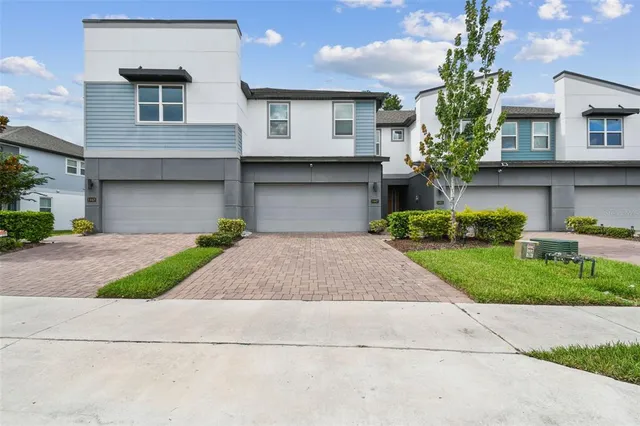 a front view of a house with a yard and a garage