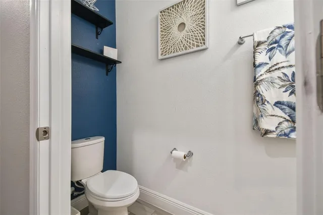 a white toilet sitting next to a shower curtain