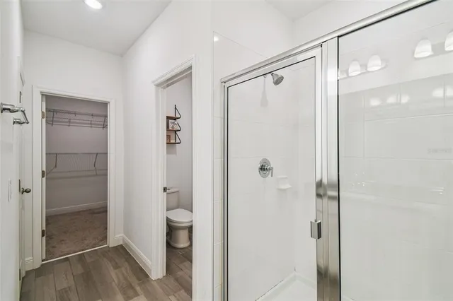 a bathroom with a shower and a toilet