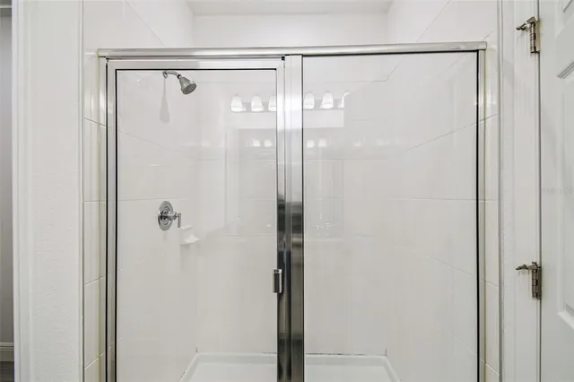 a bathroom with a glass shower door