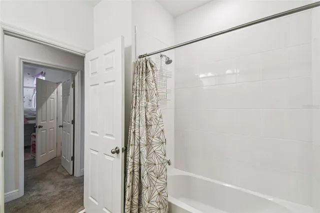a bathroom with a shower and a bath tub
