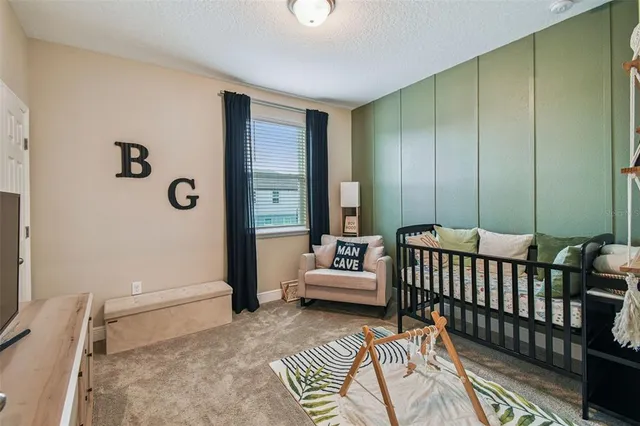 a bedroom with furniture and a window