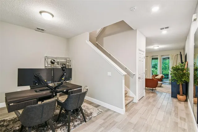 a view of a workspace with furniture and wooden floor