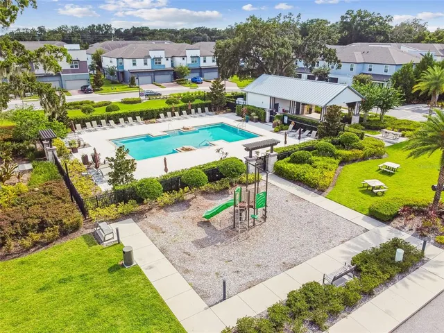 aerial view of a house with a garden and lake view