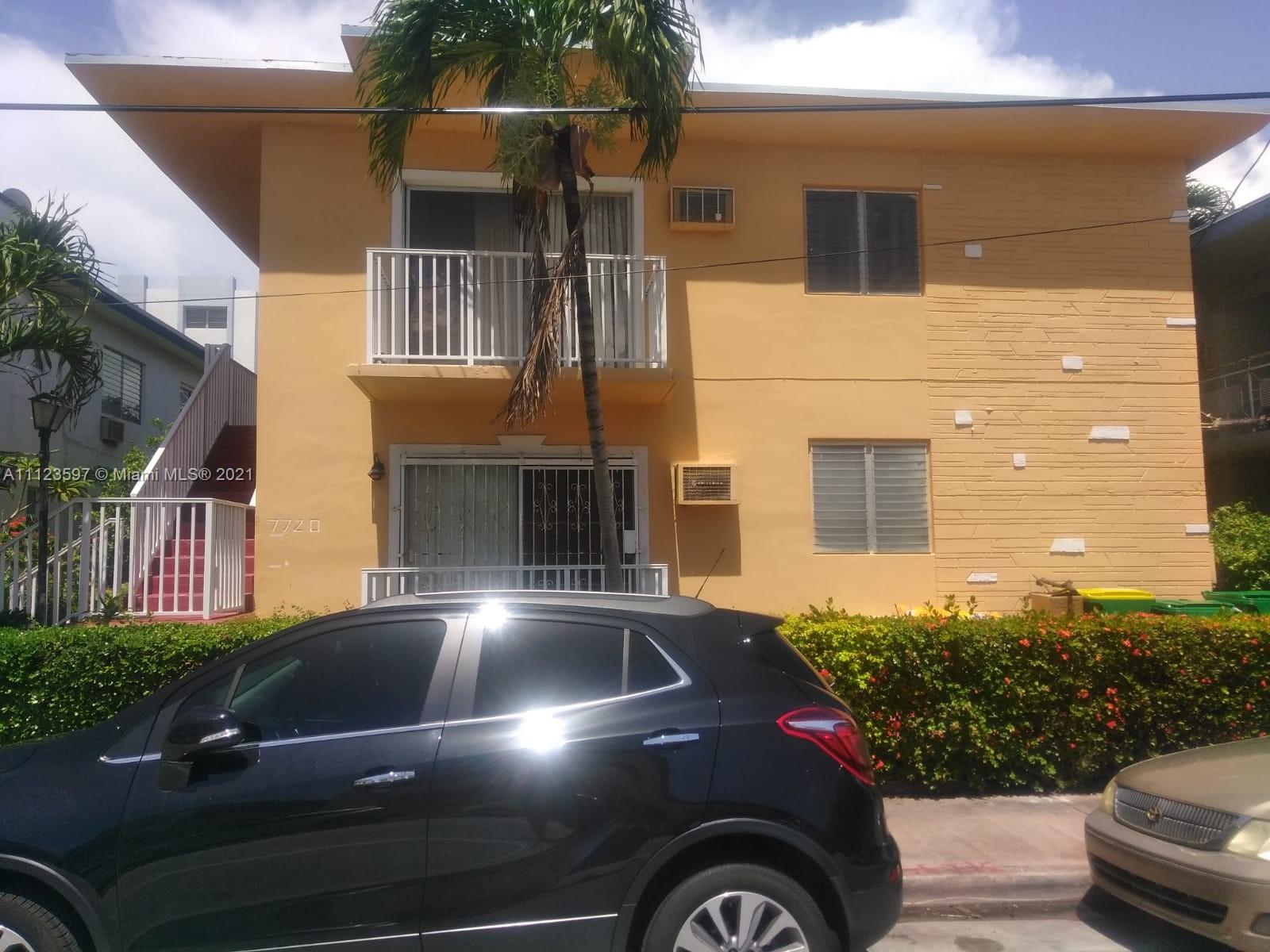 a view of building with car parked