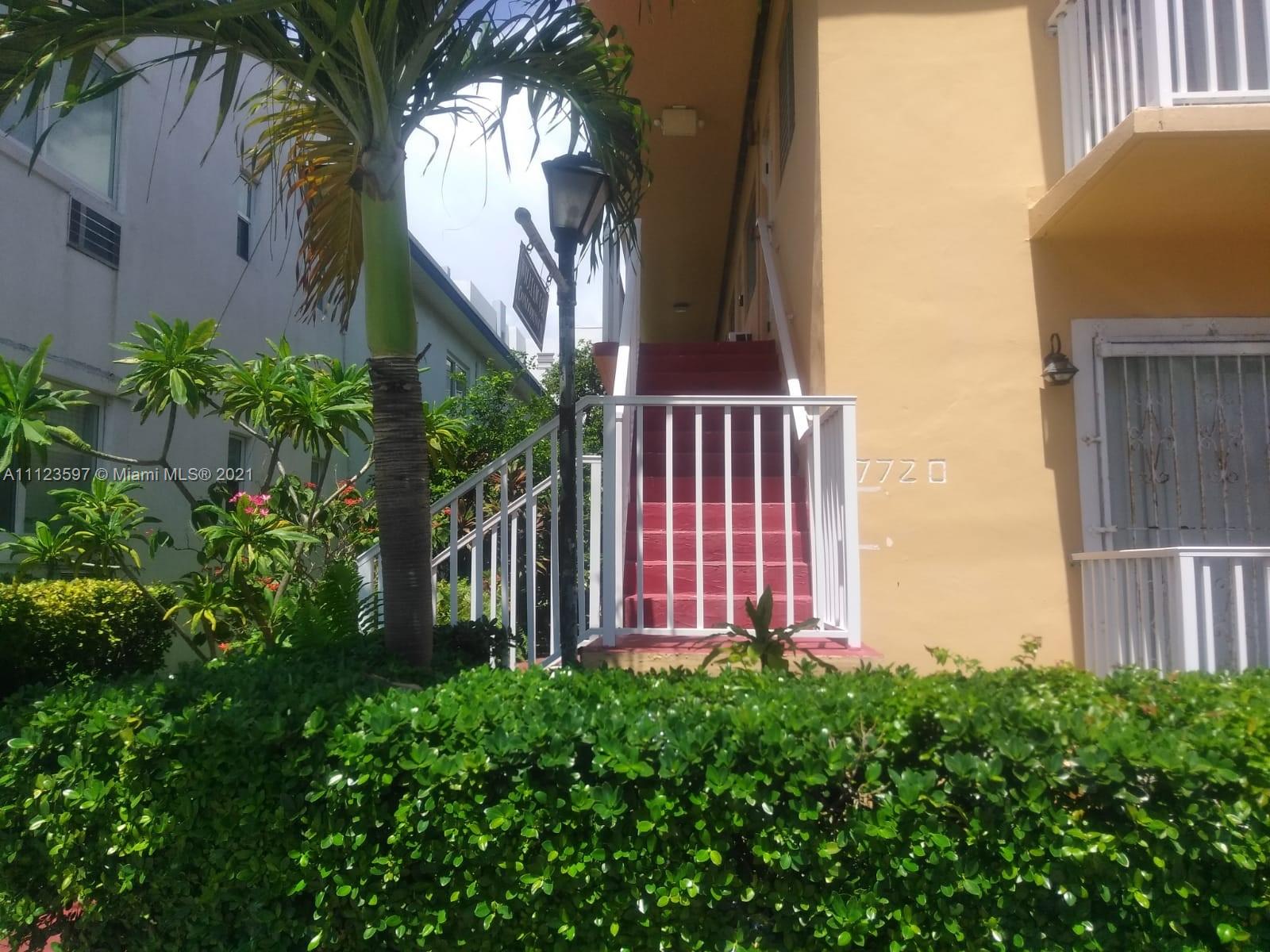 7720 Harding Avenue, Unit 1 Miami Beach, FL 33141 - Photo 5 of 7 a view of a house with a small yard and plants