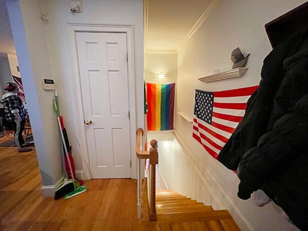 57 Dwight Street, Unit G Boston, MA 02118 - Photo 13 of 28 a view of a hallway with wooden floor and stairs