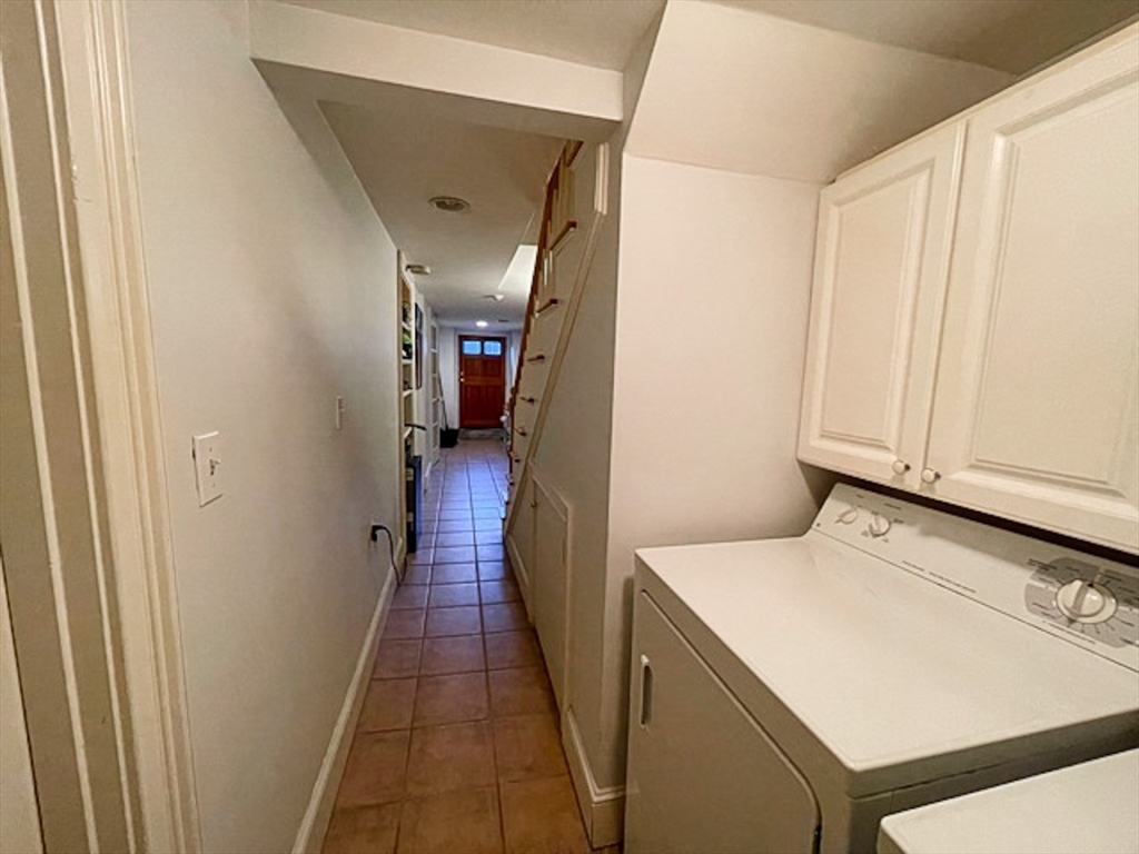57 Dwight Street, Unit G Boston, MA 02118 - Photo 16 of 28 a hallway with washer and dryer
