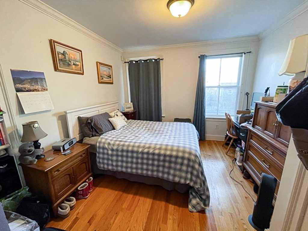 57 Dwight Street, Unit G Boston, MA 02118 - Photo 6 of 28 a bedroom with a bed and wooden floor