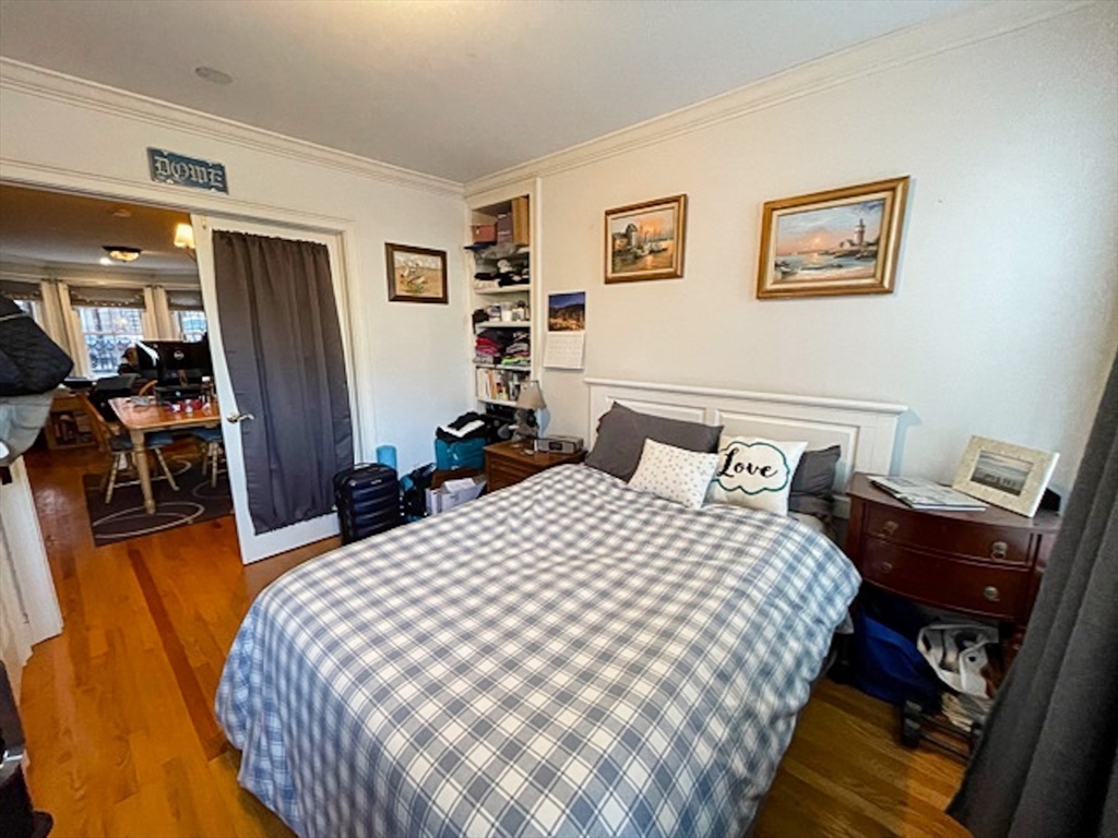 57 Dwight Street, Unit G Boston, MA 02118 - Photo 8 of 28 a bedroom with bed and wooden floor