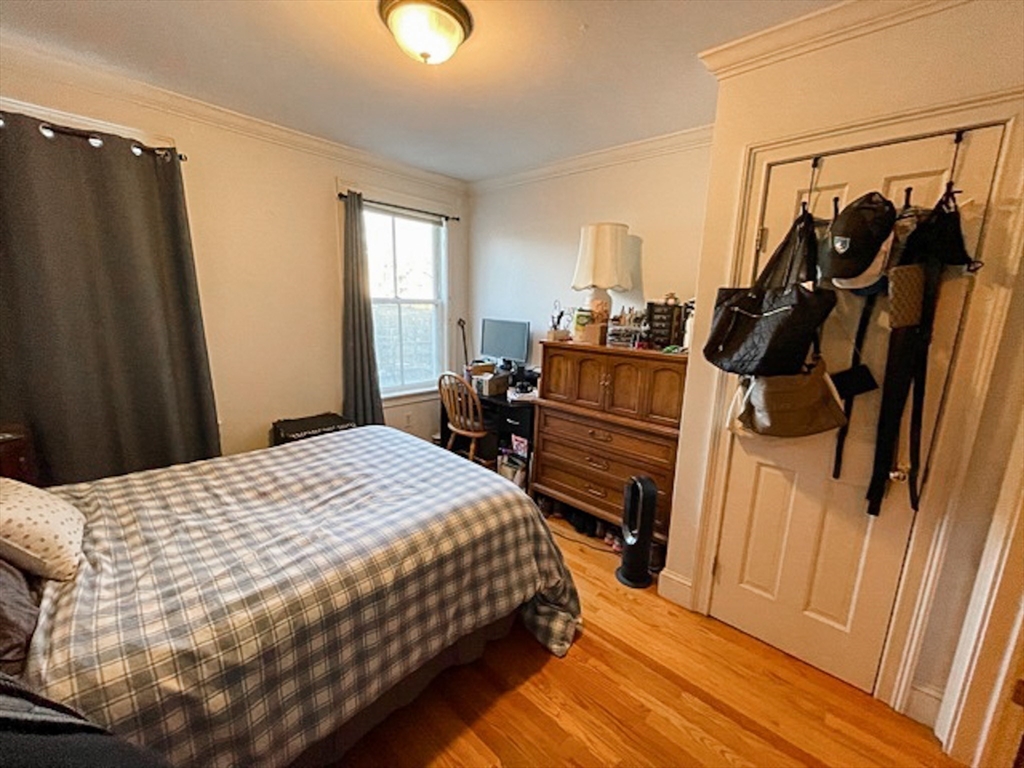 57 Dwight Street, Unit G Boston, MA 02118 - Photo 9 of 28 a bedroom with a bed and wooden floor