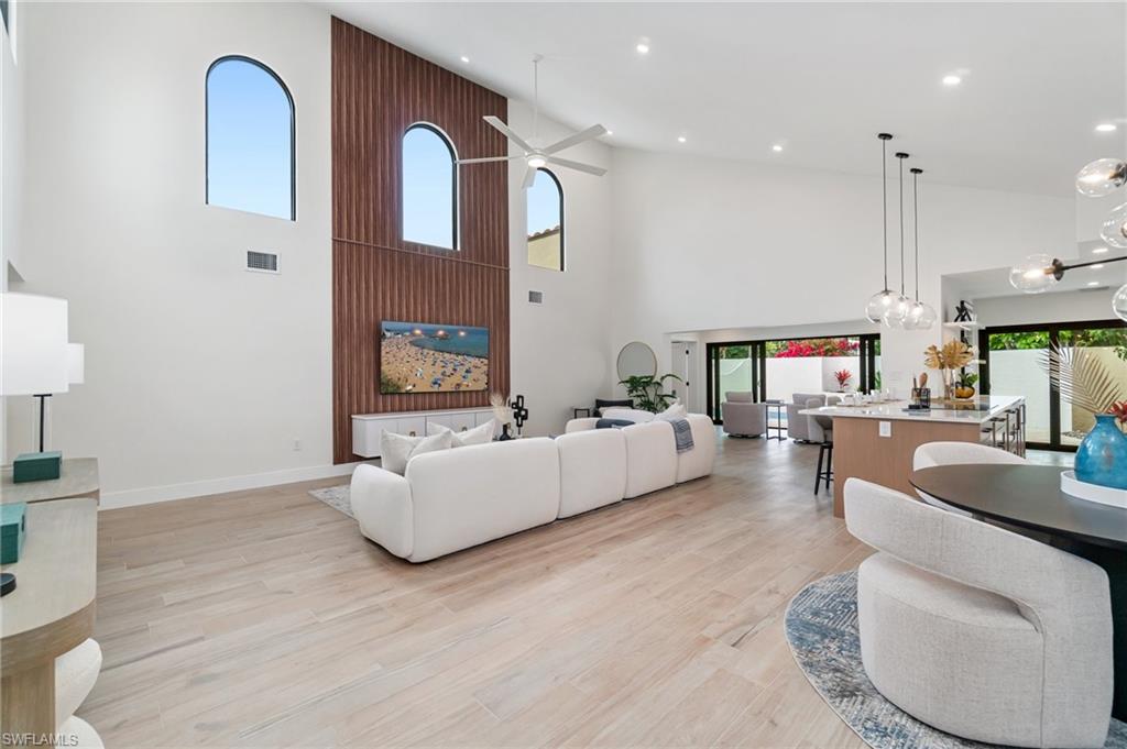 6804 Sand Pointe Circle Naples, FL 34108 - Photo 13 of 49 Redesign has created a spacious living area with walnut accent wall