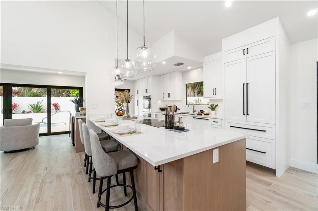 6804 Sand Pointe Circle Naples, FL 34108 - Photo 17 of 49 Oversized island with quartz counter top, seating and electric cook top - ideal for entertaining