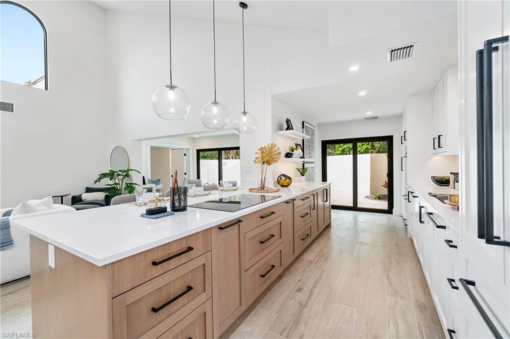 6804 Sand Pointe Circle Naples, FL 34108 - Photo 18 of 49 Quartz counter tops, electric cook toop, soft close drawers and cabinets...nothing spared