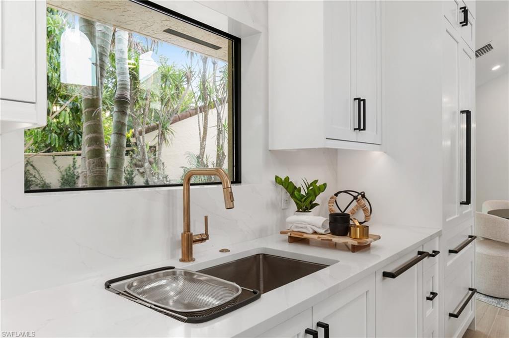 6804 Sand Pointe Circle Naples, FL 34108 - Photo 20 of 49 Details such as backsplash quartz, enframing the window, rose gold fixtures. Stunning!