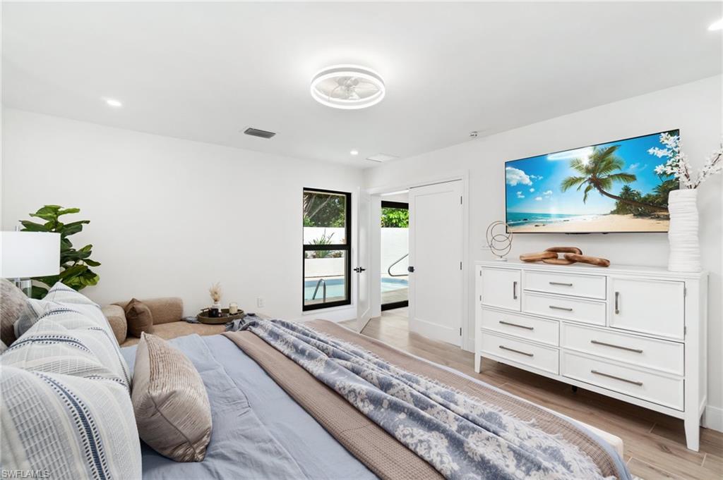 6804 Sand Pointe Circle Naples, FL 34108 - Photo 26 of 49 Primary bedroom with pool view and double entry doors