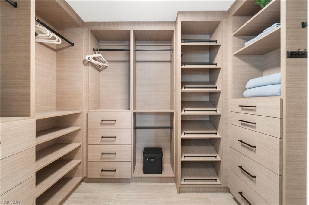 6804 Sand Pointe Circle Naples, FL 34108 - Photo 27 of 49 Expansive custom closet with ample drawer space and slanted shoe storage